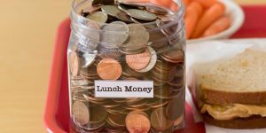 Jar of money on a school lunch tray